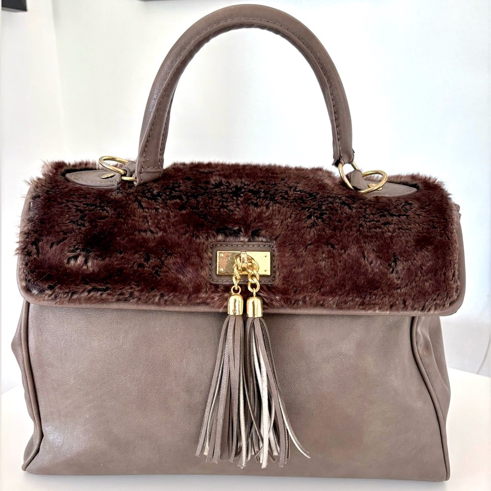 Taupe Aldo satchel bag with brown faux fur. Gold trims with tassels.
